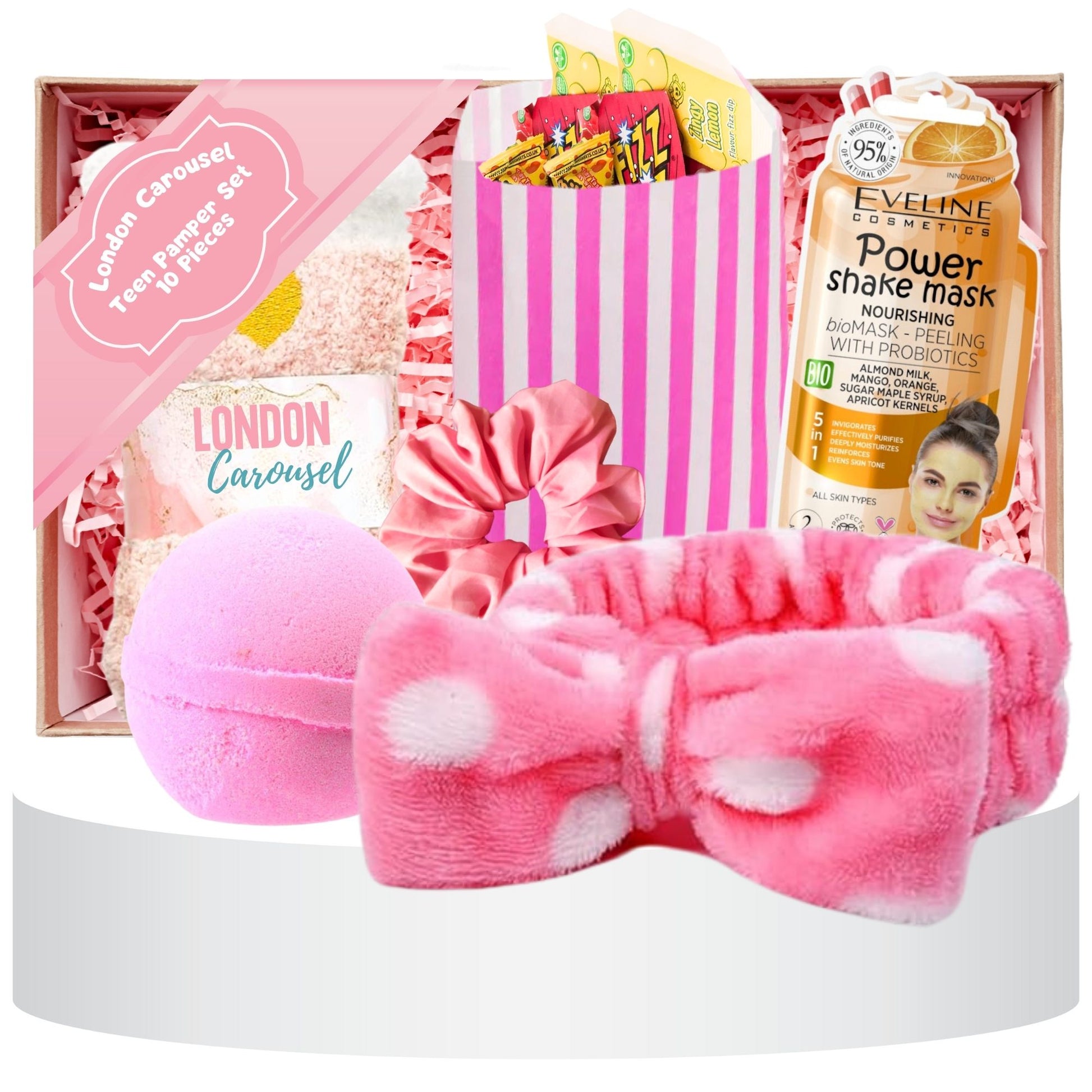 A delightful Pamper Me Pretty Hamper Gift featuring a soft skincare headband, a 7th Heaven peel-off face mask, bubble gum scent bath bombs, cozy socks, a hair scrunchie, and a bag of sweet treats.