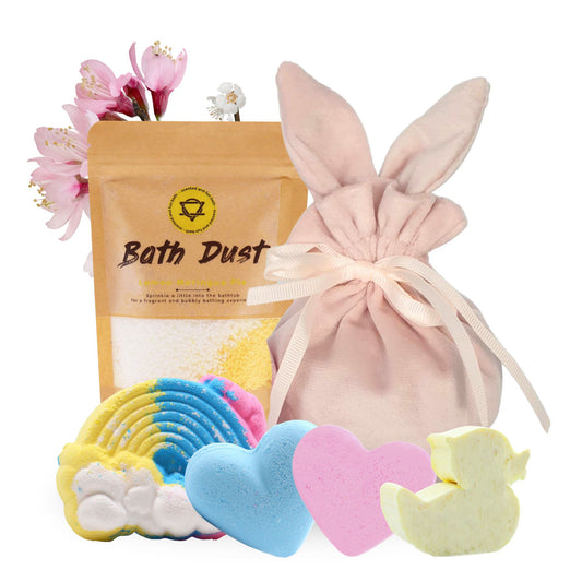 A delightful Easter Bunny Bag and Bath Spa Gifts set featuring pink Easter velvet bunny bags, a bath bomb with a rainbow design, lemon meringue pie bath dust (190g), pink bubblegum love heart bath bomb (70g), blue baby powder love heart bath bomb (70g), and a yellow duck guest soap with a fizzy peach scent.